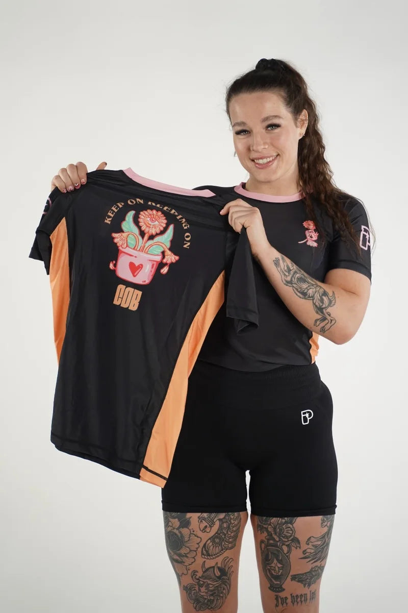 Chanel smiling and holding a COB graphic shirt
